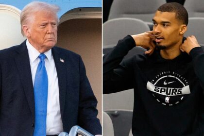 President Donald Trump reacts to Spurs star Victor Wembanyama folding his arms during the anthem