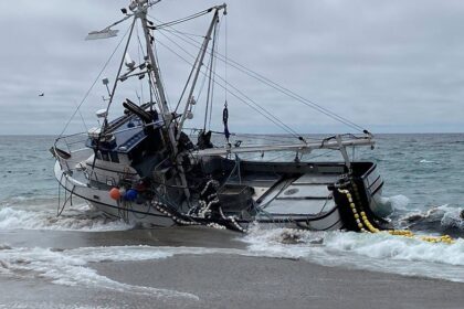 Massive fishing boat runs aground at popular beach with 1,000 gallons of diesel on board
